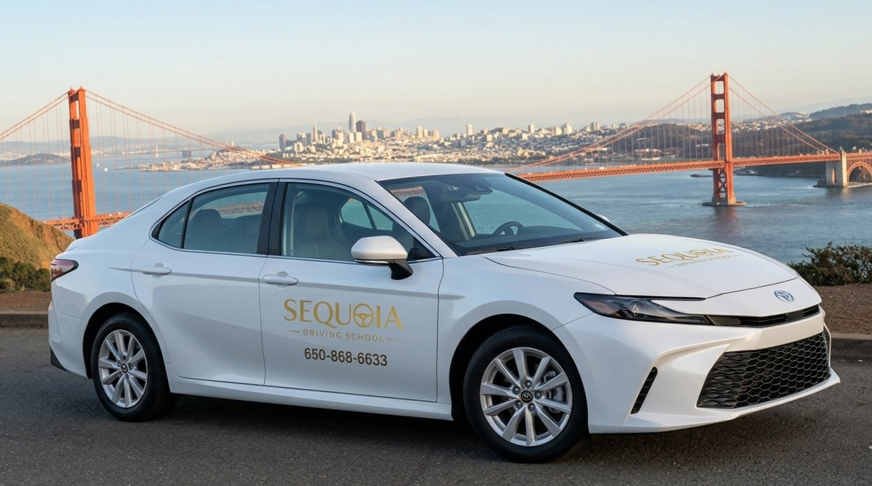 The white Toyota Camry training car parked above the Golden Gate Bridge